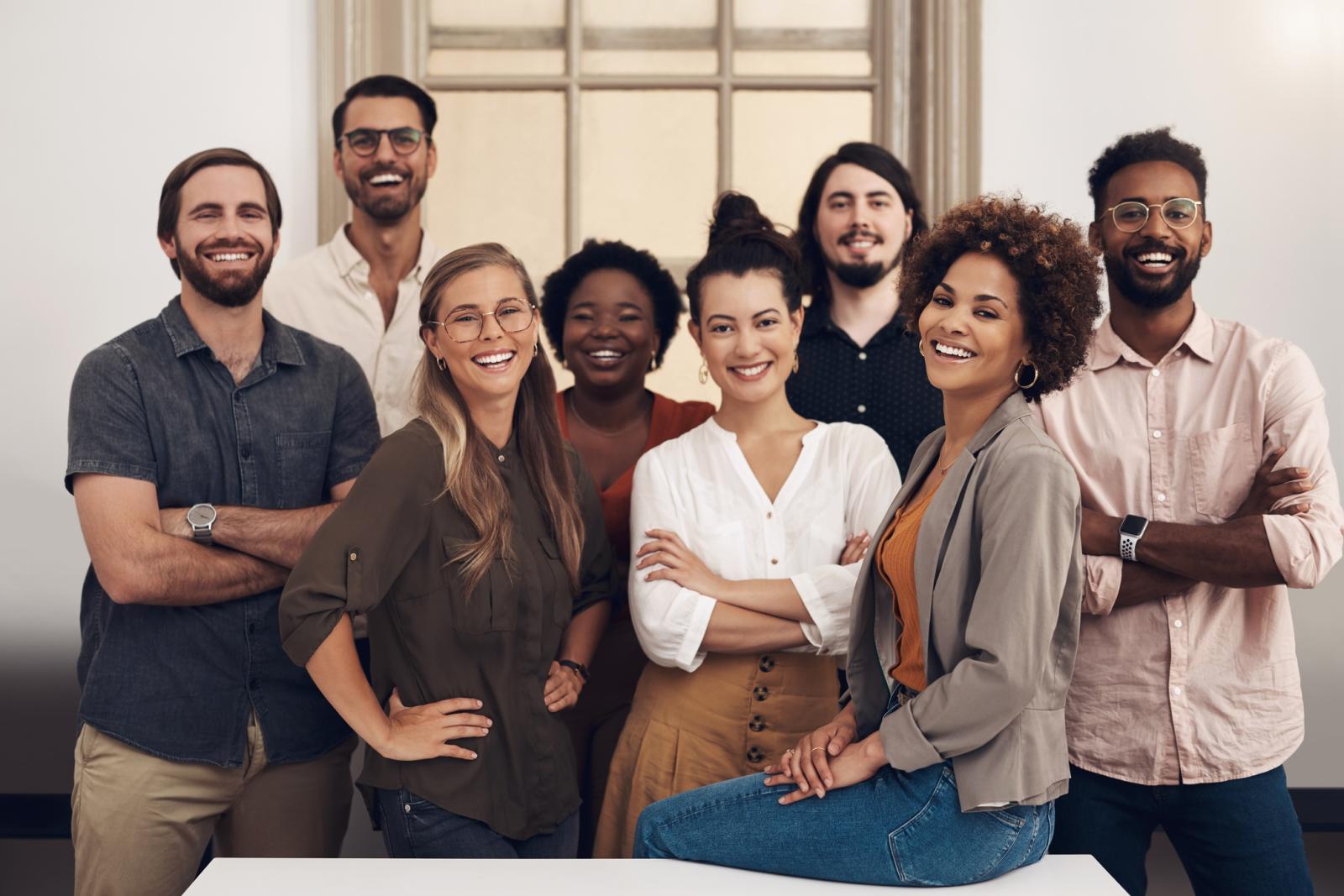 Portrait of a group of businesspeople standing together in an office.