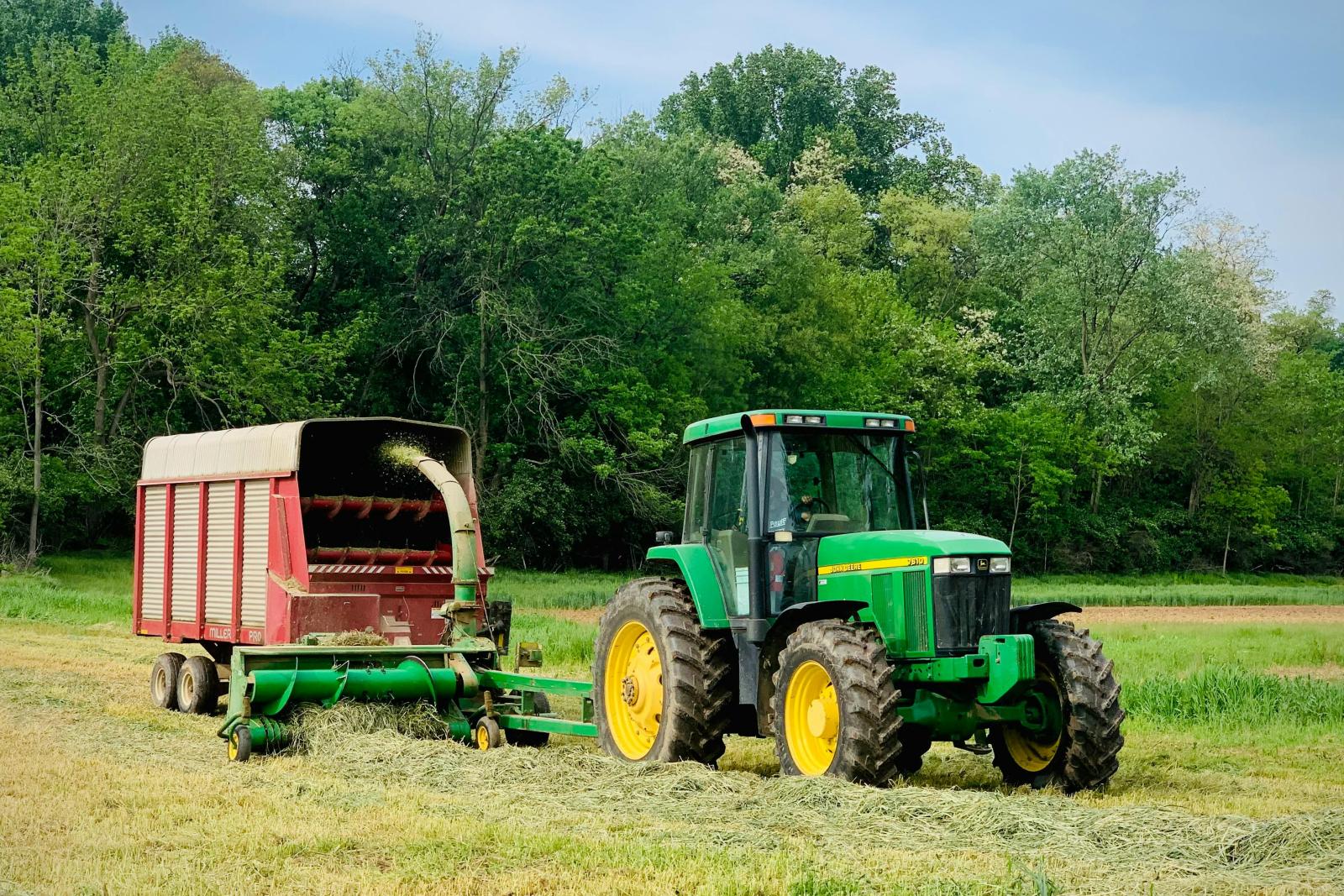 Green Tractor Harvesting Hay in Lancaster Field